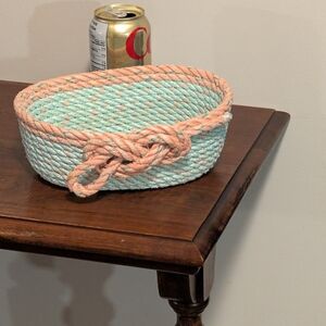 Handwoven Mint and Peach Rope Basket With Knot On The Front.